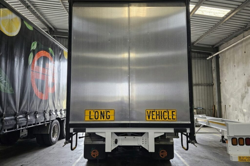 Interior view of an enclosed trailer with a rear ramp door.