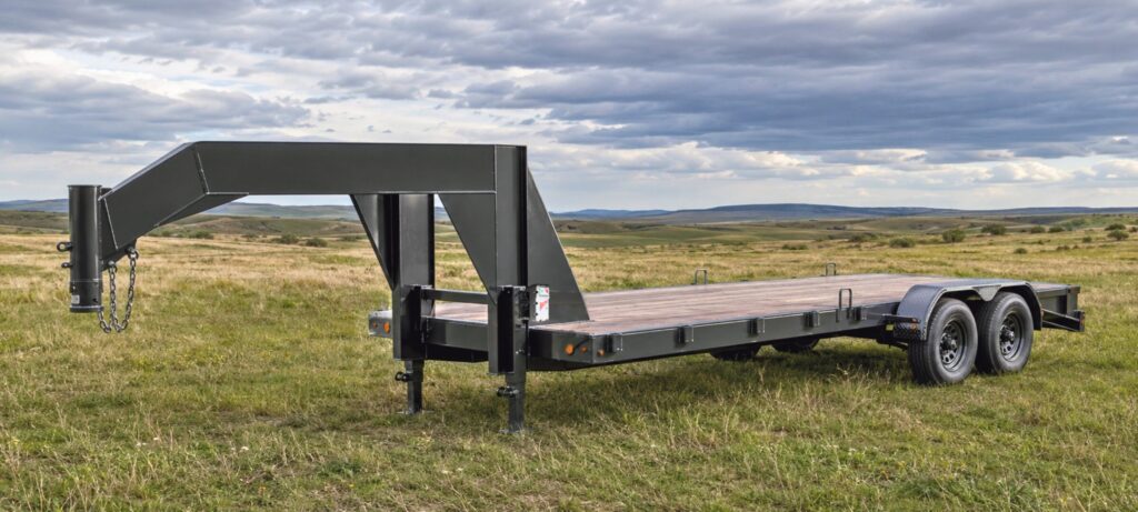 Gooseneck flatbed trailer fitted with drop-leg landing gear.